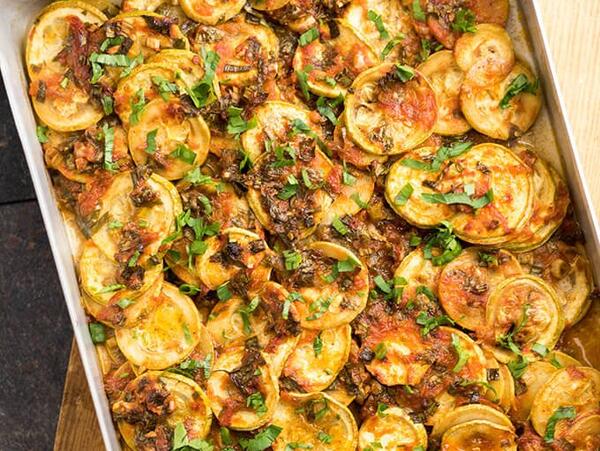 A pan of Vegan Tomato Zucchini Casserole on top of a cutting board